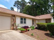 Ranch style home with a landscaped yard and attached garage at 646 Post Road Dr, Stone Mountain, GA 30088