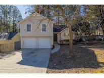 Two-story house with attached two-car garage and landscaped yard at 2105 Sandtree Sw Ct, Atlanta, GA 30331