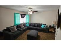 Spacious living room featuring a large sectional sofa and plush ottoman at 4701 Flat Shoals Rd # 48G, Union City, GA 30291