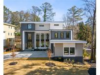 Modern two-story home with gray and white exterior, landscaped yard, and driveway at 4063 Rickenbacker Dr, Atlanta, GA 30342