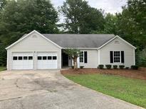 Newly painted house with 2-car garage and manicured lawn at 2301 River Station Ter, Woodstock, GA 30188