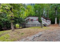 Cozy wooded lot with charming one-story home and deck at 533 N Little Victoria Rd, Woodstock, GA 30189