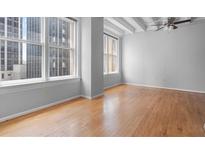 Spacious living room with hardwood floors and large windows offering city views at 32 Peachtree Nw St # 804, Atlanta, GA 30303