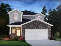 Two-story home with stone and shingle accents, two-car garage, and landscaped yard at 704 Lily Blossom Path, Lawrenceville, GA 30045