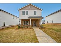 Charming two-story home with stone accents, covered entryway, and well-maintained lawn at 1260 Firefly Field Trce Trce, Lawrenceville, GA 30045
