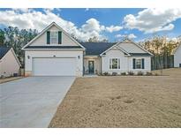 Craftsman style home with white siding, gray roof, and a two-car garage at 180 Eryn Ter, Covington, GA 30014