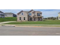 Two-story home with brick and siding exterior, landscaped lawn, and driveway at 205 Blanton Ln, Stockbridge, GA 30281