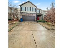 Two-story house with a brown brick and beige vinyl exterior, a two-car garage, and a concrete driveway at 231 Magnaview Dr, Mcdonough, GA 30253