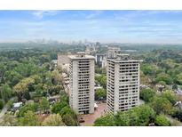 Aerial view of two high-rise buildings with city skyline in the background at 2575 Peachtree Ne Rd # 11D, Atlanta, GA 30305