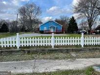 Cute blue house with white picket fence and spacious yard at 6435 Strickland St, Douglasville, GA 30134