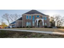 Stunning brick home featuring grand entrance, arched windows, and meticulously maintained lawn at 331 Wages Rd, Auburn, GA 30011