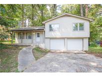 Ranch style home with attached two-car garage and landscaped yard at 3309 Poplar Dr, Lawrenceville, GA 30044
