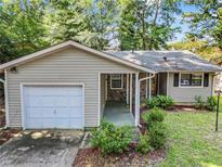 Ranch style home with attached garage and landscaped yard at 778 Villa Way, Jonesboro, GA 30238