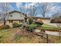 Charming brick home with well-manicured front yard landscaping and an attached two-car garage at 2458 Haverford Way, Decatur, GA 30032