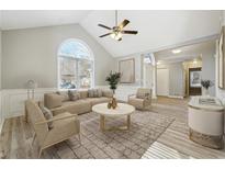 Bright living room featuring a large window, vaulted ceiling, and modern furnishings at 20 Trace Ct, Covington, GA 30016