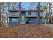 Charming split-level home with a bright green door and a landscaped front yard at 4064 Chimney Ridge Way, Ellenwood, GA 30294