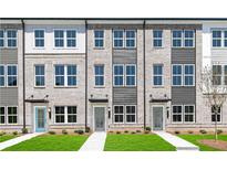 Charming townhome exteriors with brick facade, large windows, and well-manicured lawns at 2656 Brookview Nw Ln, Atlanta, GA 30318
