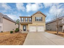 Two-story house with a two-car garage and landscaped lawn at 7502 Springbox Dr, Fairburn, GA 30213