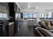 Open concept kitchen features an island, wine storage, and floor-to-ceiling windows with panoramic views at 3630 Peachtree Ne Rd # 2104, Atlanta, GA 30326