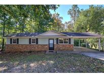Ranch style home with brick facade and carport at 3460 Meadowview Dr, Lithia Springs, GA 30122
