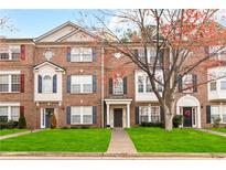 Brick townhome with landscaping and walkway at 3348 Chastain Gardens Nw Dr, Kennesaw, GA 30144