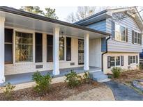 Ranch style home with attached garage, front porch, and landscaping at 4908 Mill Brook Dr, Atlanta, GA 30338