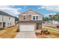 Charming two-story home featuring a stone facade and a two-car garage at 701 Lily Blossom Path Path, Lawrenceville, GA 30045