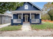 Charming craftsman style home with a blue exterior, white columns, and a spacious front porch at 774 Tift Sw Ave, Atlanta, GA 30310