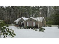 Ranch home with snow covered yard at 120 Emory Phillips Rd, Sharpsburg, GA 30277