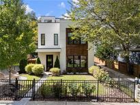 Modern two-story house with white siding, wood accents, and a landscaped front yard at 139A Walthall Se St, Atlanta, GA 30316