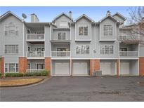 Three-story building with multiple units, garages, and landscaping at 907 Vinings Forest Se Ln, Smyrna, GA 30080