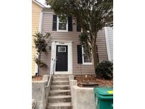 Charming townhome featuring a black front door, two stories, and a well-maintained exterior at 1799 Timber Valley Se Way, Smyrna, GA 30080