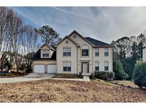 Two-story house with attached two-car garage and manicured lawn at 10845 Grenadier Ln, Alpharetta, GA 30022