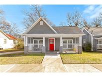 Gray craftsman style home with a red front door and porch at 1091 Longley Nw Ave, Atlanta, GA 30318