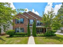 Brick two-story house with a landscaped lawn and walkway at 6684 Crane Ave, Fairburn, GA 30213