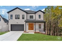 Two-story home with white brick, dark trim, and a wood front door at 9165 Golfview Ln, Covington, GA 30014