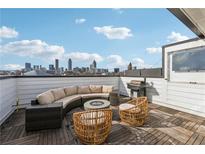 Stunning rooftop deck with outdoor seating, a grill, a fire pit, and city views of the downtown skyline at 75 Boulevard Ne # 1, Atlanta, GA 30312
