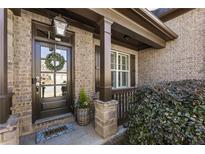 Charming brick home entrance featuring a stylish door with a decorative wreath at 4532 Summersweet Dr, Marietta, GA 30066