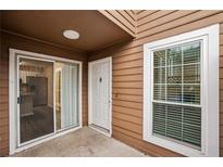 Exterior view of townhouse with sliding glass door, white door, and window at 1025 Rock Creek Ln, Norcross, GA 30093