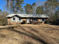 Brick ranch house with attached garage and spacious yard at 2925 Fern Valley Sw Dr, Marietta, GA 30008