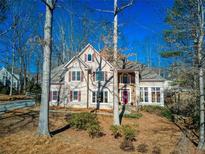 Two story house with stone accents and mature trees at 5412 Wild Flower Ct, Powder Springs, GA 30127