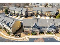 An aerial view showcasing a community of townhomes with ample parking and landscaping at 3898 High Dove Sw Way # 12, Smyrna, GA 30082