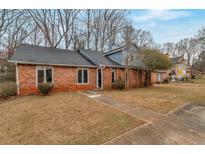 Brick ranch home with landscaped yard and walkway at 2599 Fieldstone View Se Ln, Conyers, GA 30013