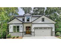 Two story home with white siding and stone accents at 7650 Abbey Glen Dr, Cumming, GA 30028