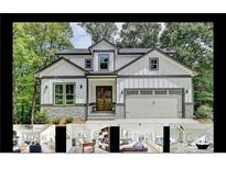 Beautiful two-story home with a two-car garage, stone accents, and a welcoming entrance at 7650 Abbey Glen Dr, Cumming, GA 30028