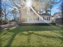 Cute ranch home with a spacious yard and mature trees at 1048 Plainview Dr, Marietta, GA 30066