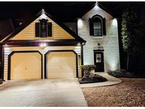 Stunning two-story home with a two-car garage and updated exterior lighting at 2587 Alvecot Cir, Atlanta, GA 30339