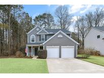 Gray two-story house with a two-car garage and landscaped lawn at 2915 Saint Andrews Ct, Cumming, GA 30041