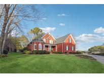 Two-story brick home with a landscaped lawn and driveway at 786 Marshview Nw Ln, Kennesaw, GA 30152