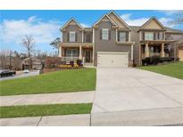 Two-story house with gray siding, landscaping, and a long driveway at 406 Providence Walk St, Canton, GA 30114
